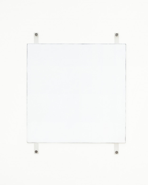 A white square with dark edges hangs on a white wall using four exposed fasteners with bolts, two on the top and two on the bottom.