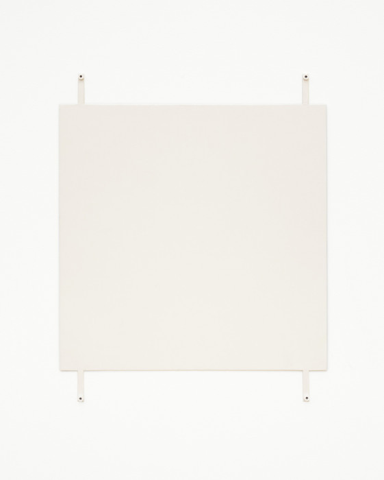 A off-white square hangs on a white wall using four exposed fasteners with white bolts, affixed to the bottom and top of the work and near the corners.
