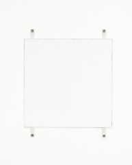 A white square with dark edges hangs on a white wall using four exposed fasteners with bolts, two on the top and two on the bottom.