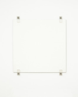 A white square hangs on a white wall using four exposed fasteners with bolts, two on the top and two on the bottom.