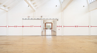 Bold red measurements run the length of a massive white wall that is interrupted by a doorway opening leading into another large space. The visible measurements read 9' 8